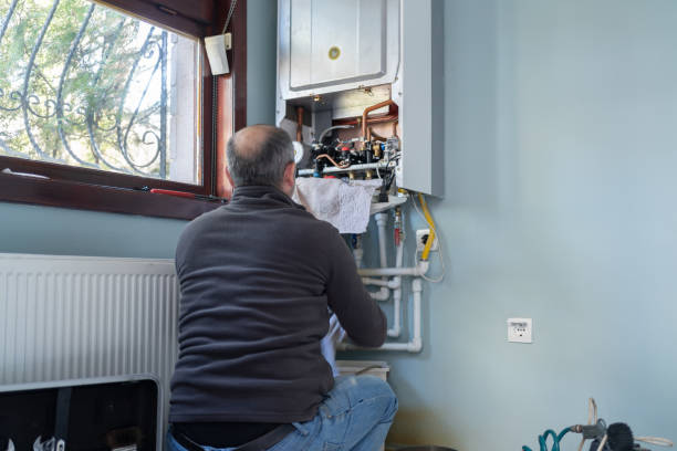 technician repairing natural gas combi boiler at home technician repairing natural gas combi boiler at home